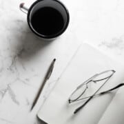 coffee and notepad on a marble table
