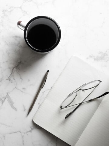 coffee and notepad on a marble table